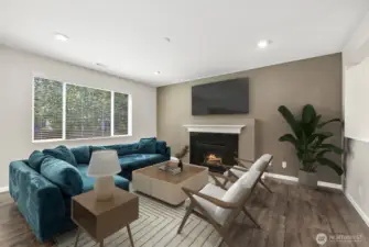 **Partially virtually staged** Cozy space for living room with natural light beaming in. Features gas fireplace and wall-mount for your TV.