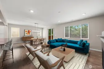 **Partially virtually virtually staged** Open concept living room full of natural light. Flows into dining space, then leading out to backyard.