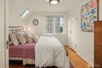 One of three bedrooms on upper level with skylights