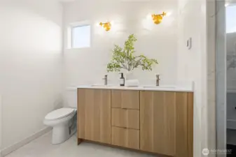 Upper level bathroom with double sinks and stand up shower
