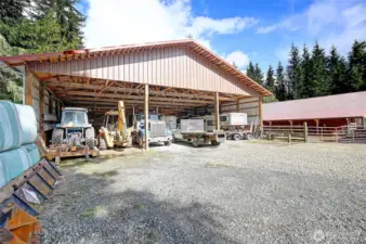 Covered area on North side of the indoor arena. Large covered parking for trailers and RV or could be stalls.