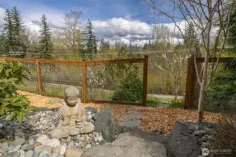 This gate leads to sitting areas and a private trail that meets up with the city trail you can see in the background