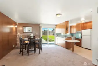 Adorable kitchen/dining with natural light peeping though backyard