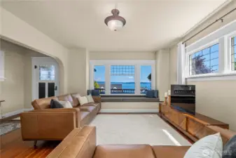 Expansive windows flood the living room with natural light and frame breathtaking water views.