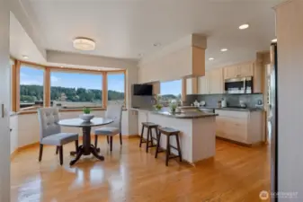 A bay window is a part of the nook area, and there is easy access to the front deck to watch the sunrise over Mt. Rainier from this room. The nook area provides a cozy and inviting space, enhanced by the natural light from the bay window, making it an ideal spot for morning views and relaxation.