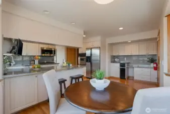 A view from the nook towards the kitchen, highlighting additional cabinetry and the trash compactor. This space used to accommodate the washer and dryer.
