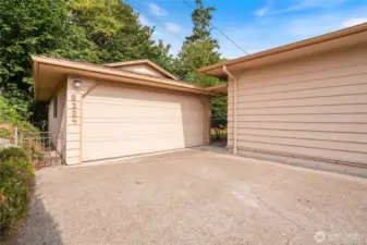 The detached garage with storage area behind allows for additional coverage for toys/vehicles.