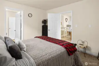 Primary bedroom with access to the full bathroom and the living space.