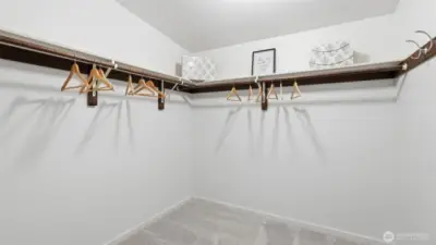 Enjoy this generous primary closet with built-in shelving and room to organize.