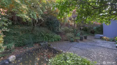 Goldfish pond and established greenery create a relaxing natural backdrop.