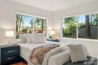 Beautiful sunny bedroom has a second entrance off the side deck