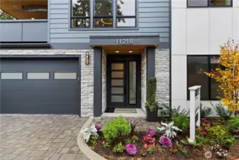 Colorfully landscaped and architecturally detailed, the front entry offers a welcoming approach to this contemporary residence.