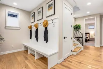 Thoughtfully designed mudroom with custom built-in bench seating, storage cubbies, and hooks. A perfect everyday landing zone that keeps the home organized and clutter-free.