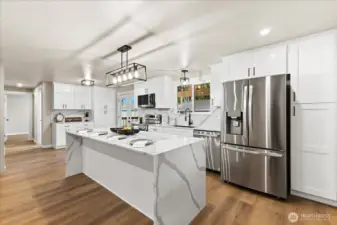 8' x 3' beautiful quartz island has plenty of room for 4. Cabinets extend into dining area.