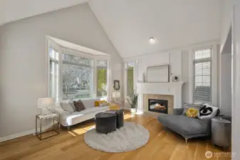 Vaulted ceilings in living room with gas fireplace and gorgeous Buchan Millwork detail. 7inch wide white oak wood floors throughout main floor