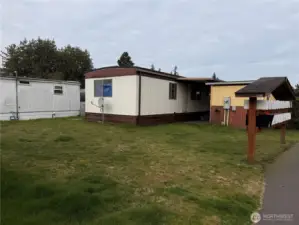 View of home from large back yard on corner unit