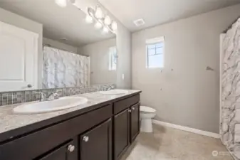 Full bathroom upstairs with double sink