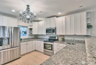 lots of cabinets, stainless appliances and granite counters