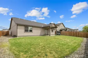 Fully fenced back yard with underground sprinkler system.