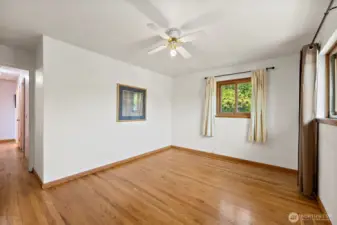 Original primary turned into 2nd bedroom at end of main hallway. Windows bring in lots of natural light and ceiling fan to keep you cool all year long.