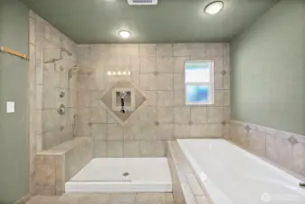 Primary en-suite bathroom complete with walk-in shower and oversized soaking tub