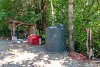 Down by the sawmill, this is the 1000 gallon tank that houses the pump that pumps to the two 3000 gallon tanks higher on the hill and then gravity feeds the rest of the property.