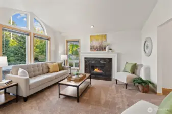 Formal living room with vaulted ceiling and cozy gas fireplace.