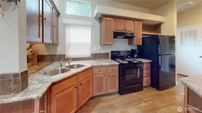 The kitchen features all appliances -  refrigerator, stove/oven, dishwasher and microwave.