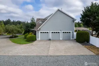 3 car garage with a ton of parking space on driveway and extra gravel parking area