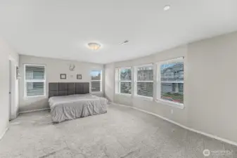 Primary suite with bay of windows and plenty of space.