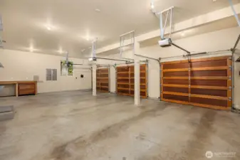 The attached garage has plenty of room for three vehicles and has a built-in electric car charger. Not shown is addiitional shelving and built-in storage.