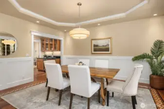 A coved ceiling, beautiful hardwood floor details and wainscoting grace the dining room.