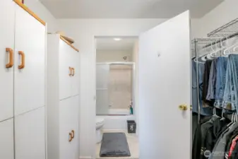 Primary closet and door to bathroom