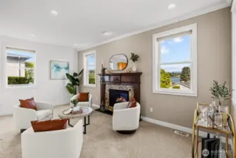 A sitting room off the kitchen with a gas fireplace is a perfect conversational hub providing a warm and inviting atmosphere.