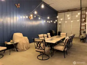 Hanging lights illuminate the sitting area in the evening with a warm, soft glow.