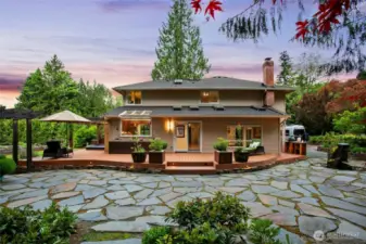 Gorgeous stone work, composite deck with lighting and magnificient grounds.