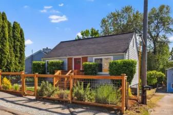 Newly landscaped front yard, freshly stained fence.