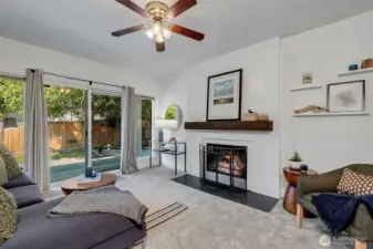 The family room with tons of light, wood wood-burning fireplace, and slider access to the patio and fully fenced back yard.