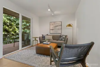The adjoining sitting alcove provides a serene retreat with access to the private deck.
