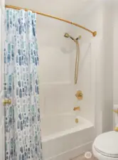 Dual access bathroom with two sinks and a shower/tub combo.