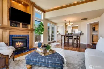 A cozy gas fireplace framed in wood anchors the living space, with a built-in nook for your TV—yes, the TV stays!