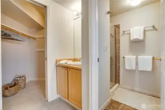 Between the vanities, a walk-in shower adds functionality, while the spacious walk-in closet provides ample storage.