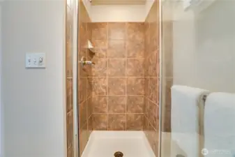 The elegant shower is both stylish and practical, completing the spa-like feel of the primary bath.