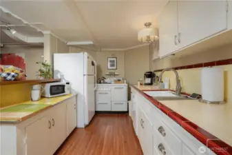 Located off of the dining area is the downstairs kitchen.  Loving this tile work and that stove?  Swoon.  So sweet.