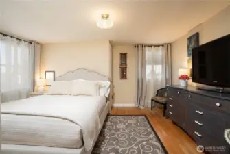 Another of the second floor bedrooms- hardwoods, period appropriate lighting, and scads of natural light.
