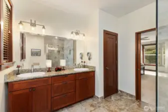 Primary bathroom with dual sinks and gorgous tile walk in shower.
