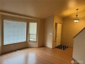 Living Room features Vaulted Ceilings, Bay Window and Main Entry nearby.