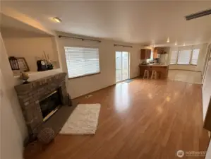 Family Room has a Beautiful Gas Fireplace, Lots of Natural Light from the windows. Nice and open to Kitchen and has a sliding door to Access the Backyard Patio.