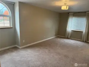 Large Primary Suite Bedroom. Lots of natural light from the windows.