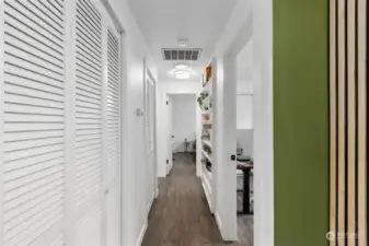 Hallway with storage and  laundry area. The cutest built in book shelf!